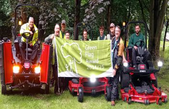 A photo of the University Grounds team holding the Green Flag award