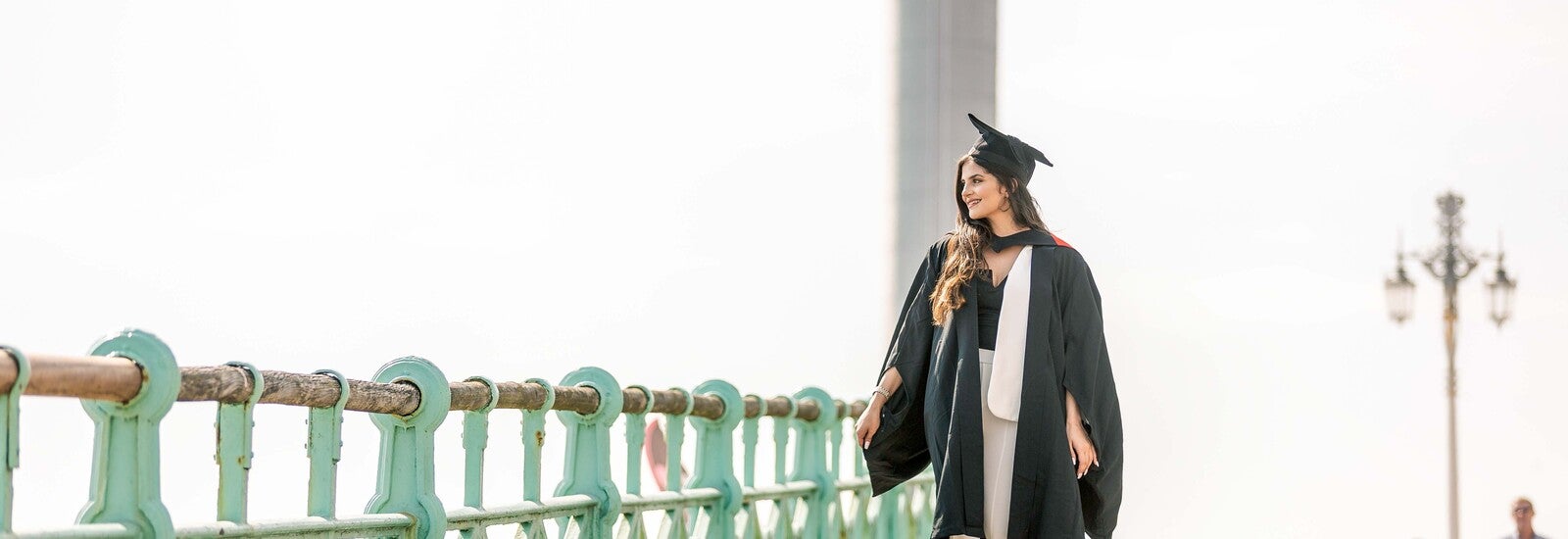 Graduate walking along Brighton seafront